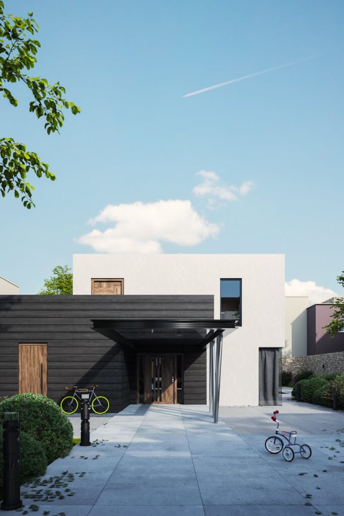 A modern minimalist house exterior, featuring a sleek design and a bicycle in the front yard.